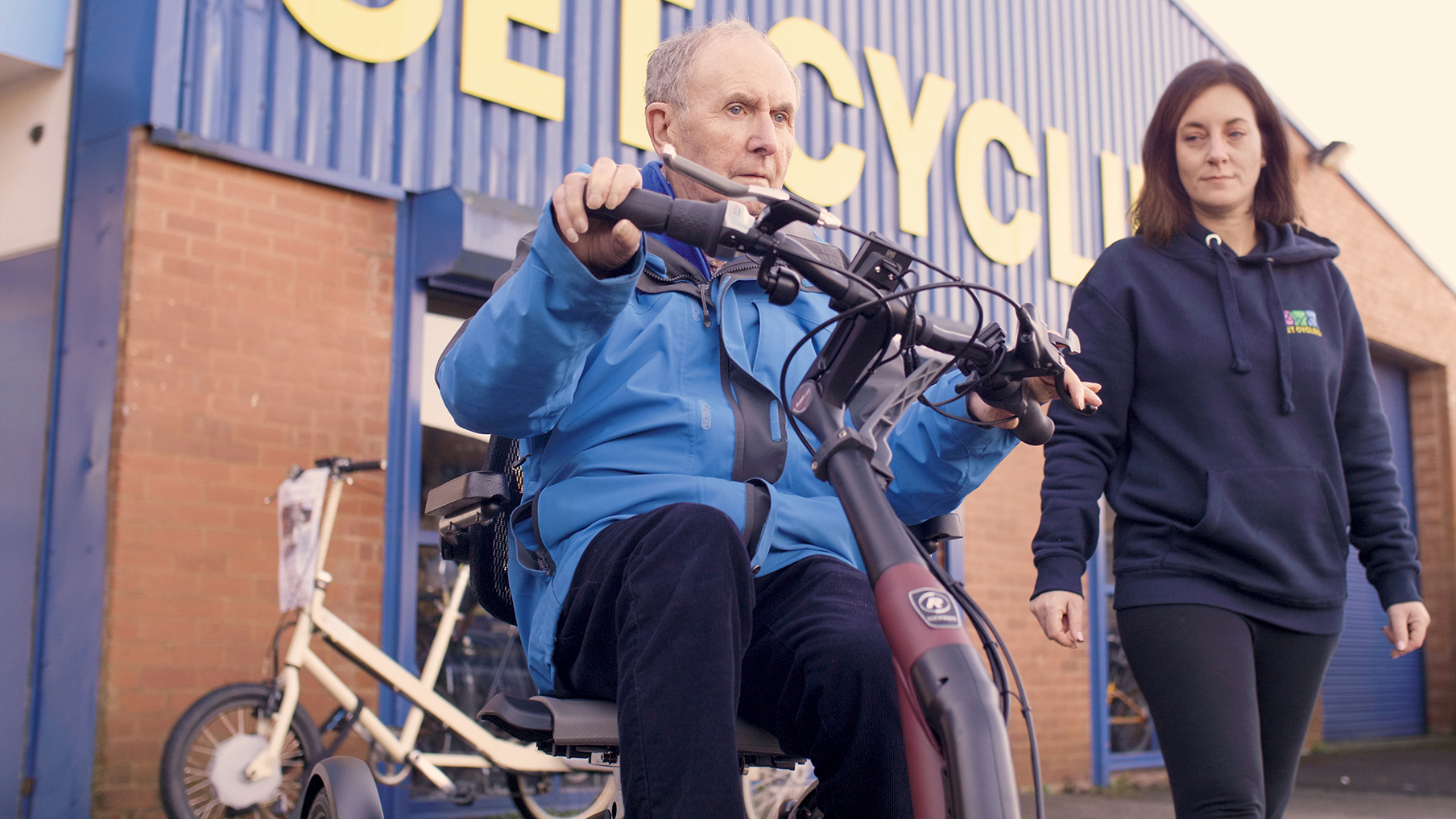 an-elderly-client-being-assisted-riding-an-accesible-bicycle.jpg
