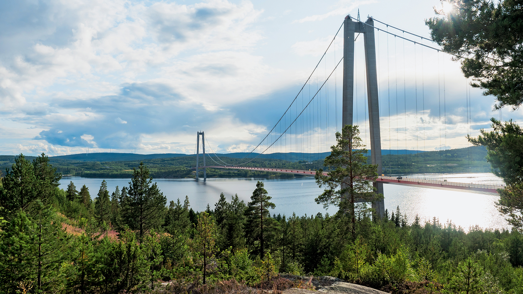 A bridge over a river, viewed from a woodland area in Hogakustenbron, Sweden