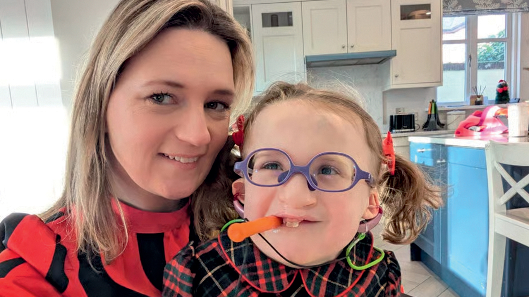 Mum and daughter smiling at the camera while taking a selfie
