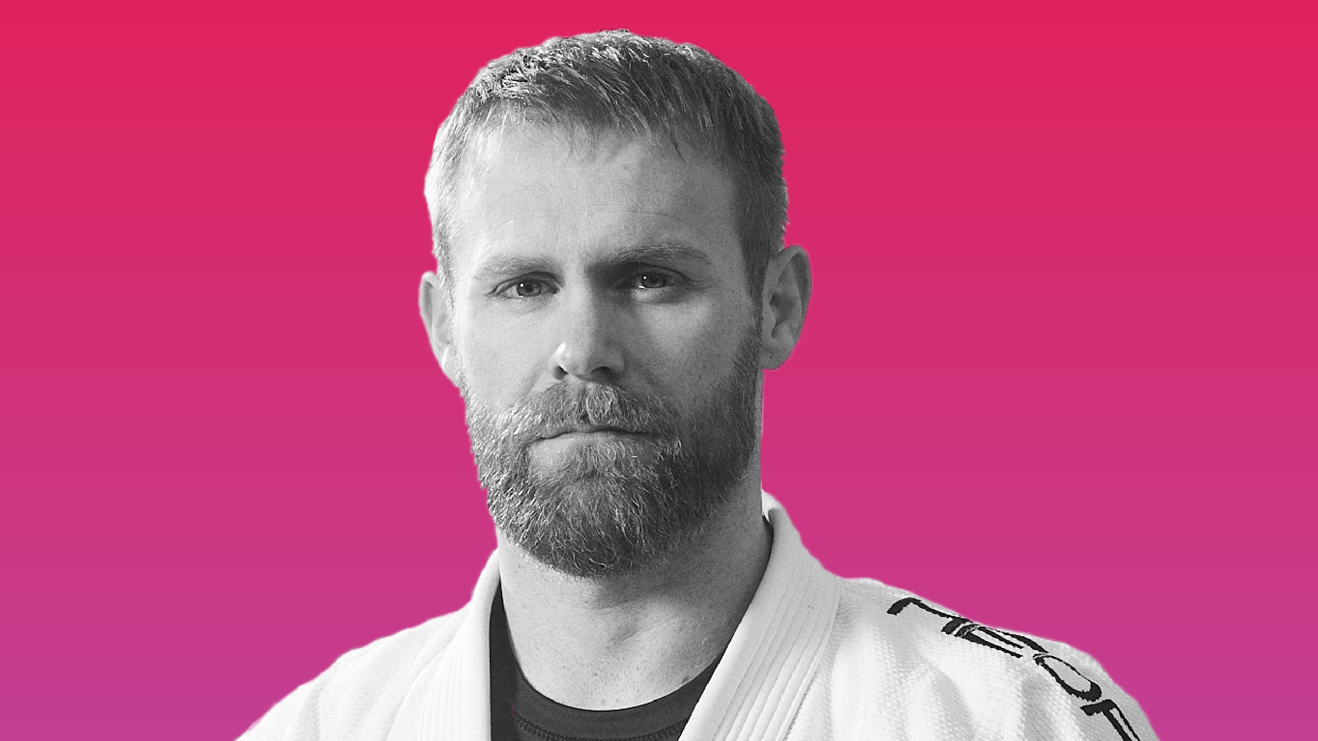 Photo of Mark in front of a pink background