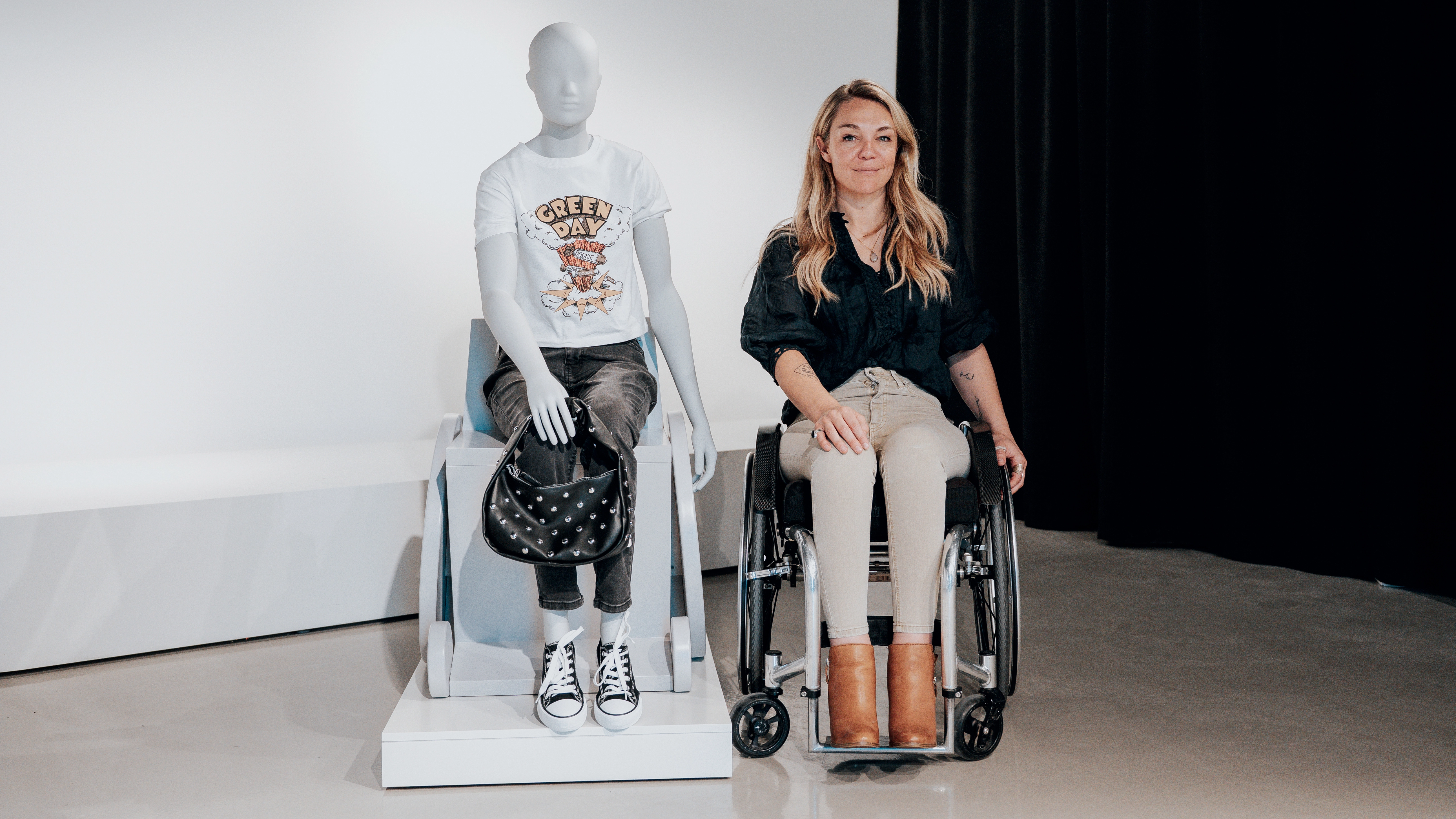 An image of Sophie Morgan posing next to a seated mannequin