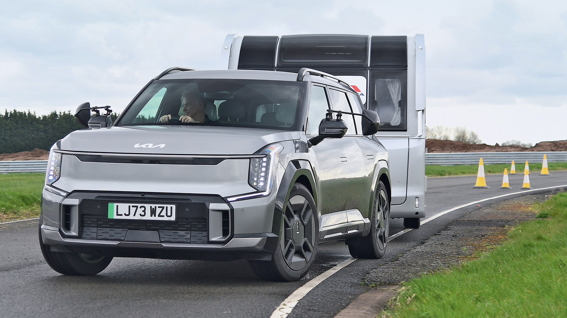 Kia EV towing a caravan