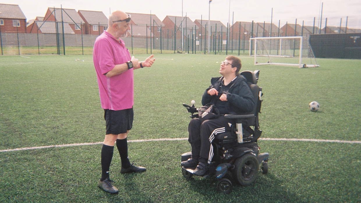 A picture of Nathan on the football pitch in his wheelchair 