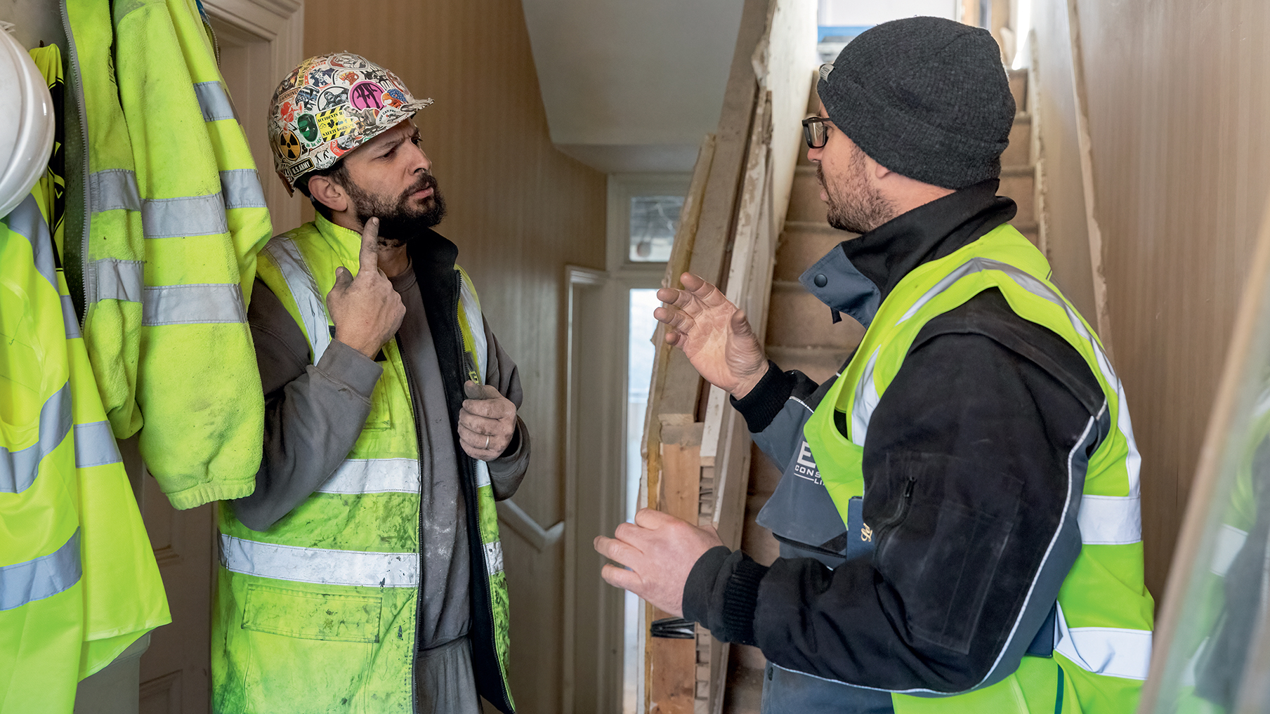 two-deaf-builders-communicating-inside-a-house.jpg
